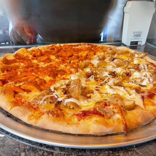 A large ONEWAY Cafe and Pizza pizza, half buffalo chicken and half chicken bacon ranch.